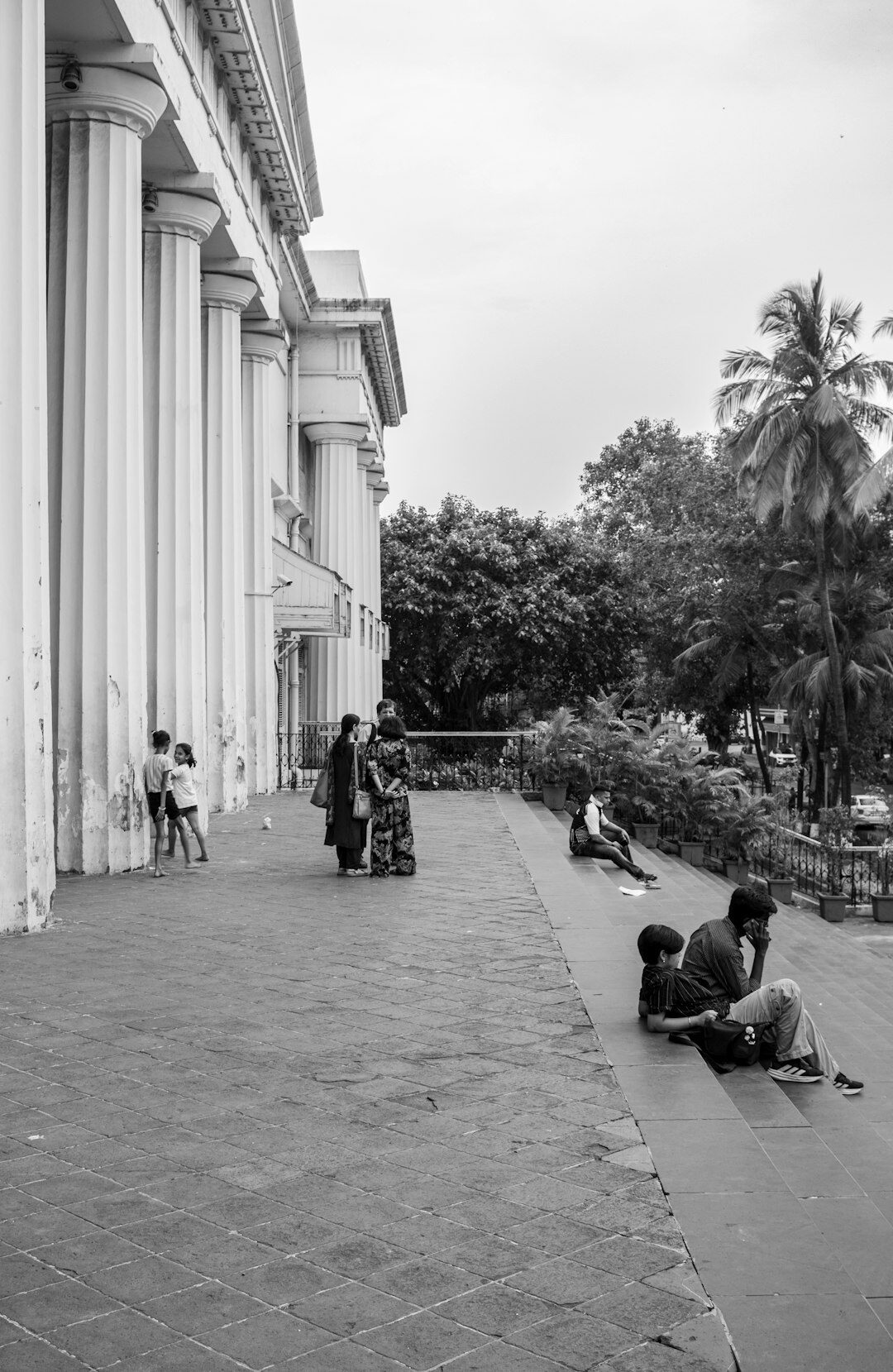 Group of people sitting in a circle having a discussion outdoors